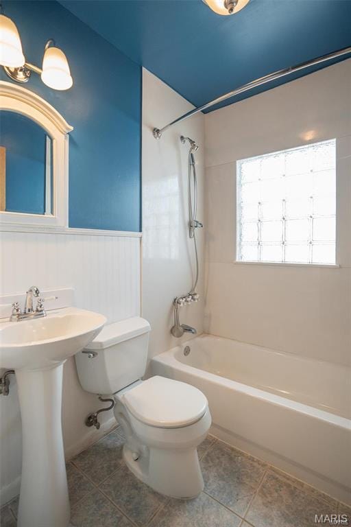 1745 Venice Ave, Granite City, IL 62040 - full bath featuring toilet, tile patterned flooring, shower / tub combination, a wainscoted wall, and a sink