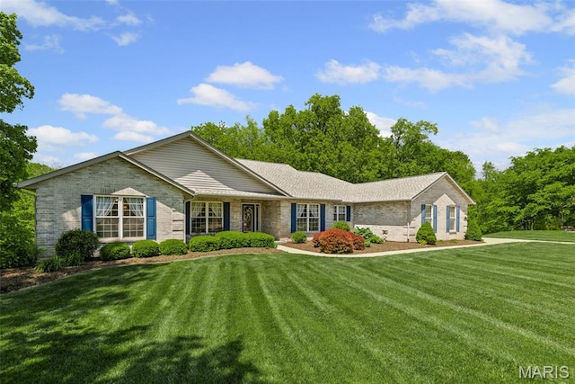 ranch-style house featuring brick siding and a front yard