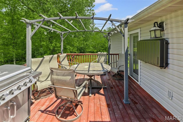 wooden terrace with outdoor dining area and a grill