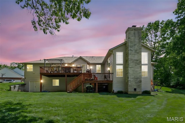 rear view of property featuring a wooden deck, a chimney, stairs, a yard, and a pergola