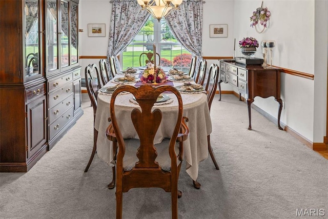 dining area with light carpet and baseboards