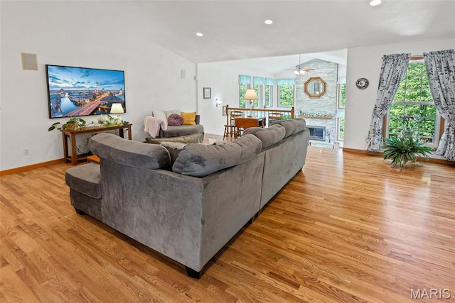 living area featuring light wood-style flooring, baseboards, recessed lighting, lofted ceiling, and a ceiling fan