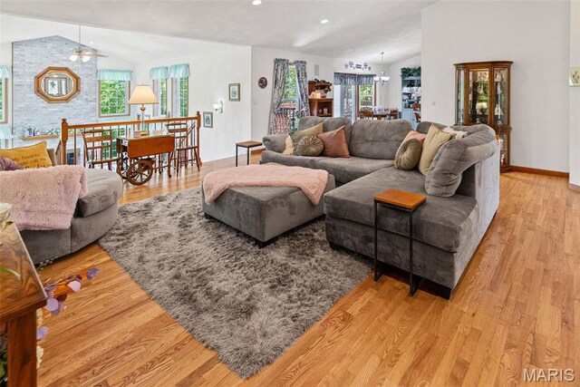 living room with lofted ceiling, light wood-style floors, recessed lighting, and ceiling fan