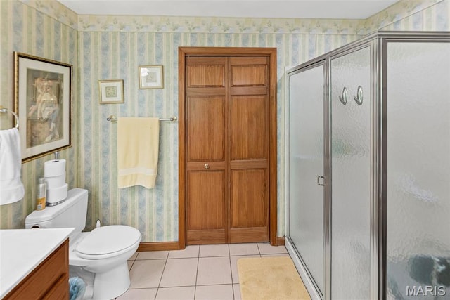 full bath with wallpapered walls, a stall shower, tile patterned flooring, toilet, and vanity