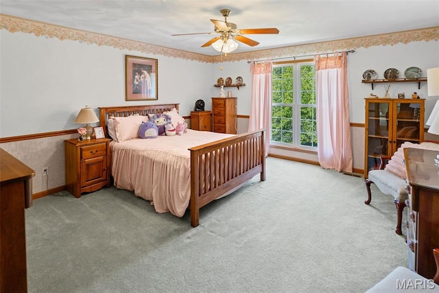 bedroom with carpet floors, a ceiling fan, and baseboards