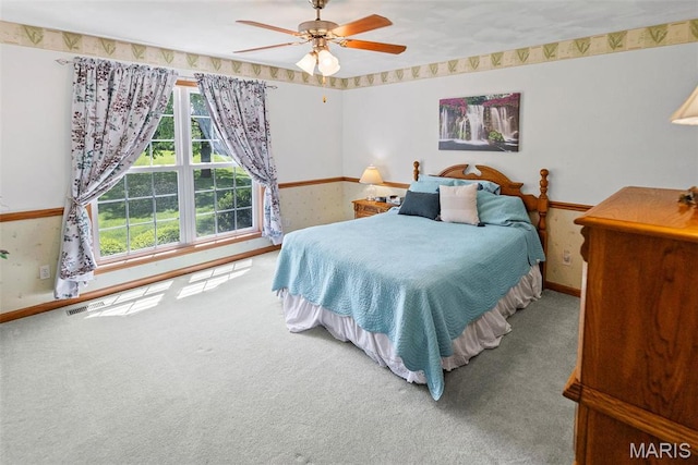 bedroom with carpet, baseboards, wallpapered walls, and ceiling fan
