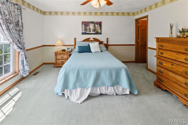 carpeted bedroom featuring baseboards and ceiling fan