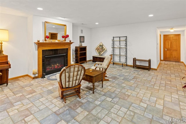 sitting room featuring baseboards, a fireplace, and recessed lighting