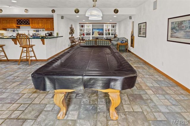 playroom featuring pool table, baseboards, stone tile flooring, bar with sink, and recessed lighting