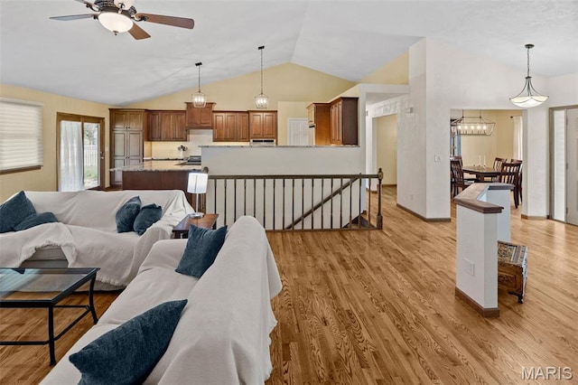 3708 Rhetts Lndg, Shiloh, IL 62221 - living area with lofted ceiling, ceiling fan, light wood-style flooring, a chandelier, and baseboards