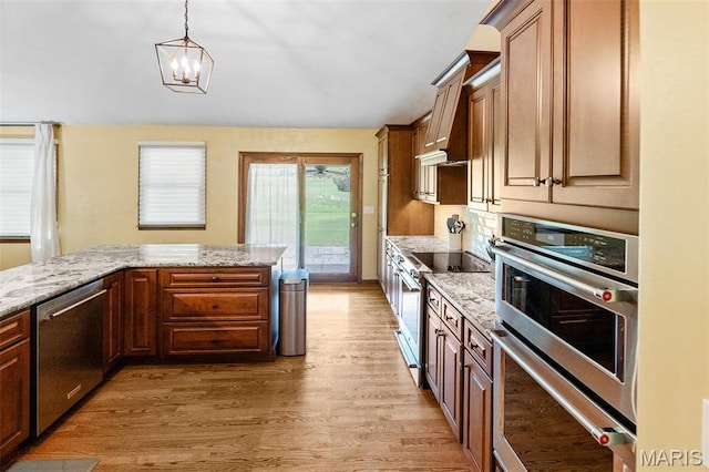 3708 Rhetts Lndg, Shiloh, IL 62221 - kitchen with appliances with stainless steel finishes, light wood-style flooring, light stone countertops, and hanging light fixtures