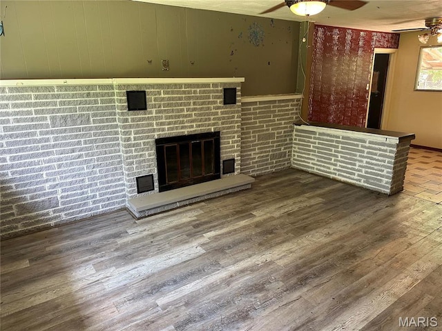 2145 Freckles Dr, High Ridge, MO 63049 - unfurnished living room with a ceiling fan, wood finished floors, and a brick fireplace