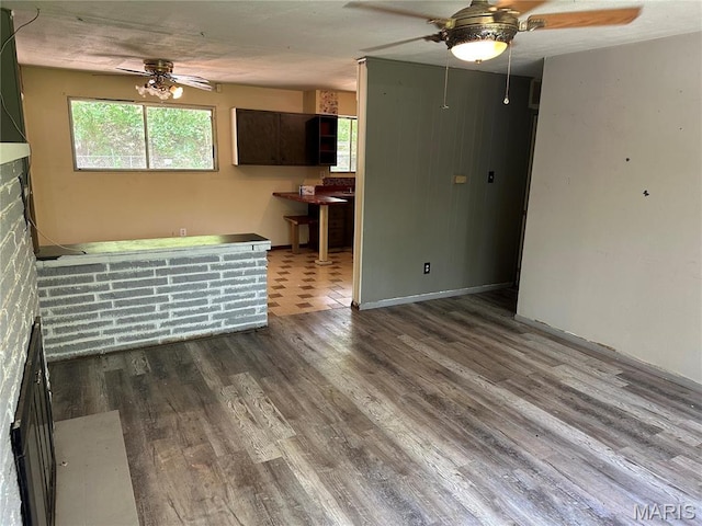 2145 Freckles Dr, High Ridge, MO 63049 - unfurnished living room featuring a ceiling fan, wood finished floors, and healthy amount of natural light