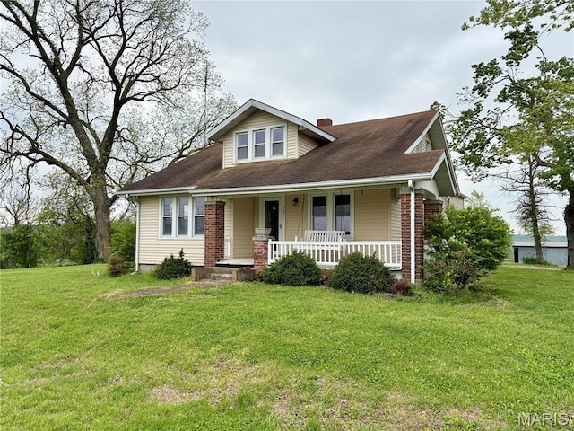 9621 Main St, Altenburg, MO 63732 - bungalow featuring a porch, a front yard, a chimney, and brick siding