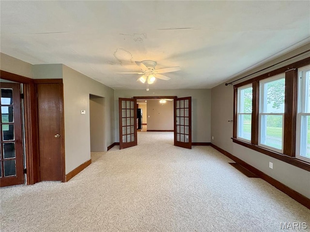 9621 Main St, Altenburg, MO 63732 - empty room featuring french doors, light carpet, baseboards, and a ceiling fan