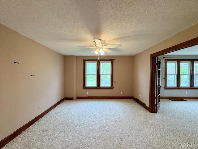 9621 Main St, Altenburg, MO 63732 - empty room featuring light carpet, ceiling fan, baseboards, and a textured ceiling