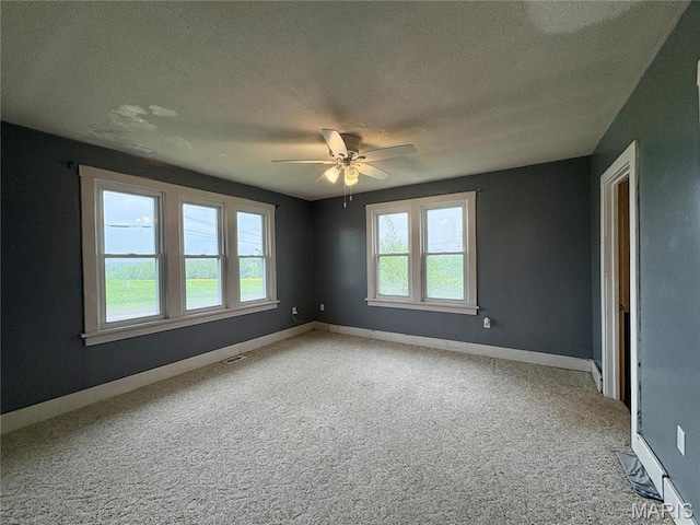 9621 Main St, Altenburg, MO 63732 - carpeted spare room featuring a textured ceiling, a ceiling fan, and baseboards
