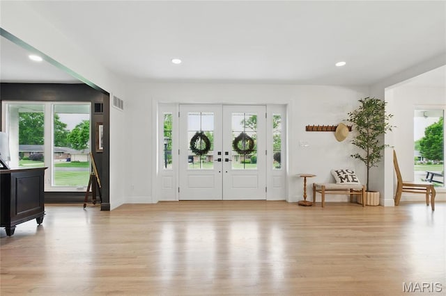 foyer featuring light wood-style flooring, baseboards, and recessed lighting