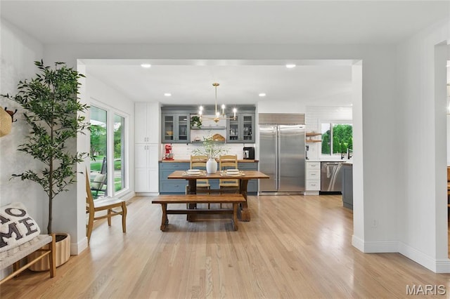 dining area with light wood-style floors, recessed lighting, and baseboards