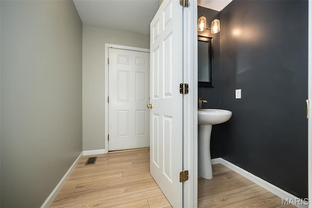 5541 Wavecrest Cir, Saint Charles, MO 63304 - bathroom with wood finished floors, baseboards, and a sink