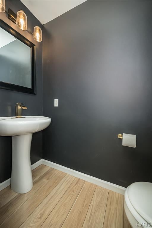 5541 Wavecrest Cir, Saint Charles, MO 63304 - half bathroom featuring baseboards, wood finished floors, and toilet