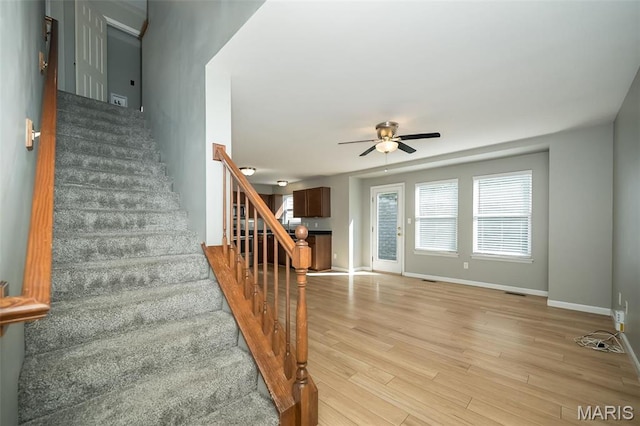 5541 Wavecrest Cir, Saint Charles, MO 63304 - stairs featuring a ceiling fan, wood finished floors, and baseboards