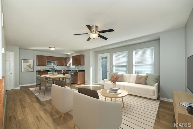 5541 Wavecrest Cir, Saint Charles, MO 63304 - living room with baseboards, light wood-style flooring, and a ceiling fan