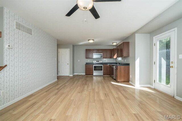 5541 Wavecrest Cir, Saint Charles, MO 63304 - kitchen with appliances with stainless steel finishes, light wood-style flooring, a sink, and baseboards
