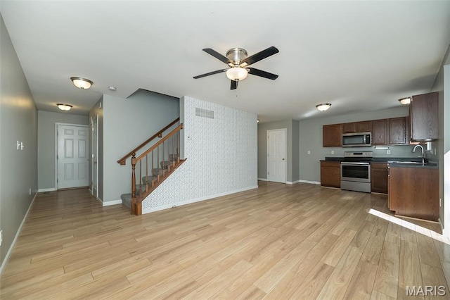 5541 Wavecrest Cir, Saint Charles, MO 63304 - kitchen featuring appliances with stainless steel finishes, baseboards, light wood-type flooring, and ceiling fan