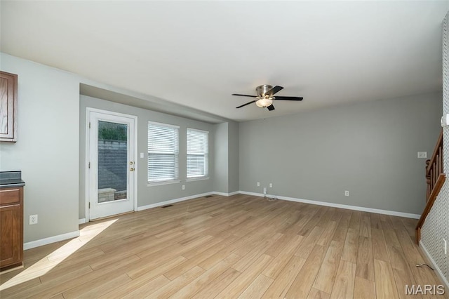 5541 Wavecrest Cir, Saint Charles, MO 63304 - unfurnished living room featuring a ceiling fan, light wood-style floors, and baseboards