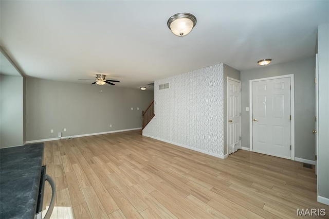 5541 Wavecrest Cir, Saint Charles, MO 63304 - unfurnished living room featuring a ceiling fan, light wood-type flooring, baseboards, and stairs