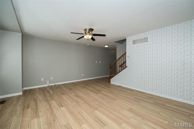 5541 Wavecrest Cir, Saint Charles, MO 63304 - unfurnished living room with light wood-style floors, stairs, a ceiling fan, and baseboards