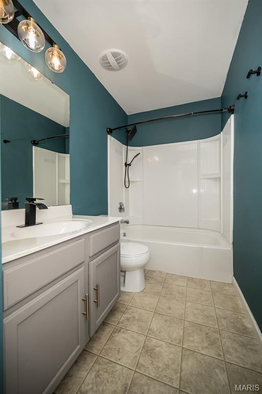5541 Wavecrest Cir, Saint Charles, MO 63304 - full bathroom with vanity, toilet, bathing tub / shower combination, tile patterned floors, and lofted ceiling