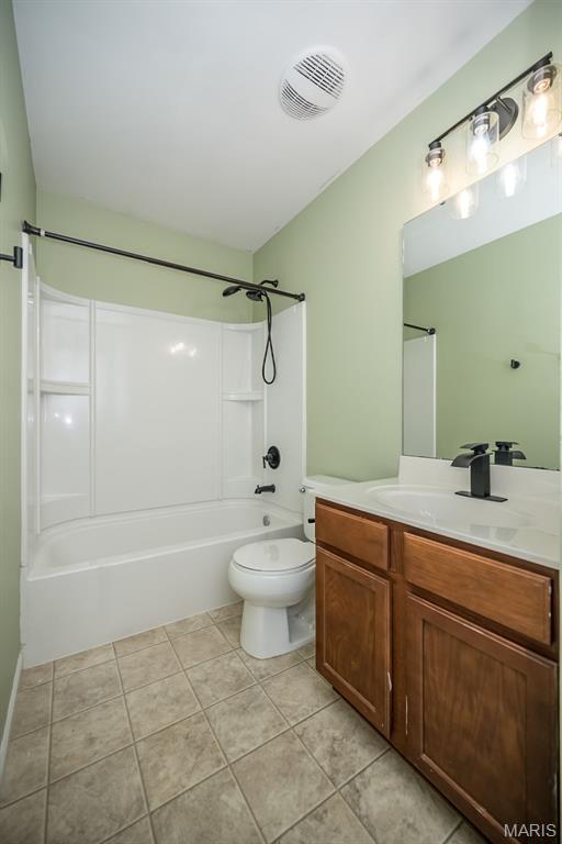 5541 Wavecrest Cir, Saint Charles, MO 63304 - full bath featuring vanity, toilet, bathing tub / shower combination, and tile patterned floors