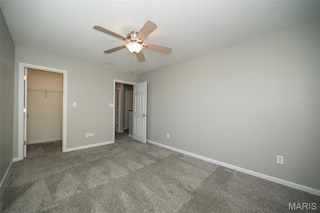 5541 Wavecrest Cir, Saint Charles, MO 63304 - unfurnished bedroom with a walk in closet, carpet, baseboards, ceiling fan, and a closet