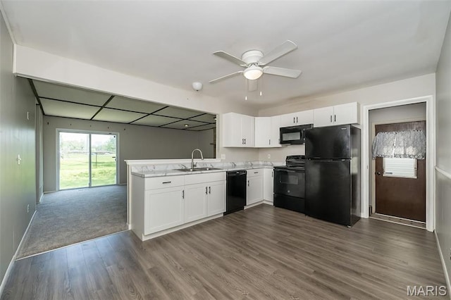 525 Angelus Dr, Florissant, MO 63031 - kitchen with black appliances, a sink, white cabinetry, light countertops, and dark wood-style floors