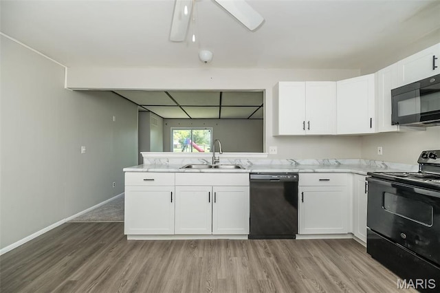 525 Angelus Dr, Florissant, MO 63031 - kitchen with black appliances, a sink, light wood-style flooring, white cabinetry, and a ceiling fan