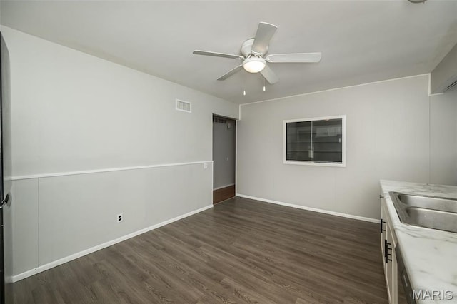 525 Angelus Dr, Florissant, MO 63031 - unfurnished bedroom with dark wood finished floors, baseboards, a ceiling fan, and a sink