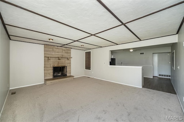 525 Angelus Dr, Florissant, MO 63031 - unfurnished living room featuring carpet floors, baseboards, a ceiling fan, and a fireplace