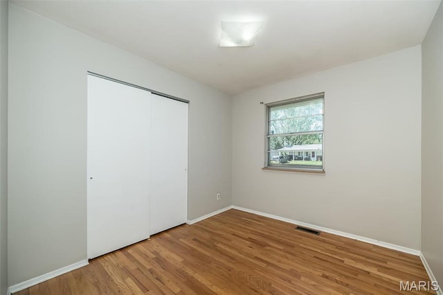 525 Angelus Dr, Florissant, MO 63031 - unfurnished bedroom featuring wood finished floors and baseboards