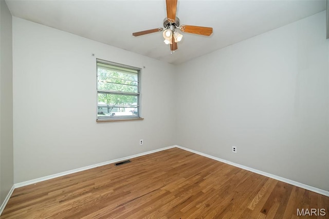 525 Angelus Dr, Florissant, MO 63031 - spare room featuring baseboards, wood finished floors, and a ceiling fan