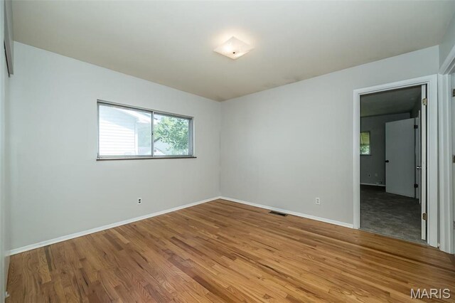 525 Angelus Dr, Florissant, MO 63031 - spare room featuring wood finished floors and baseboards