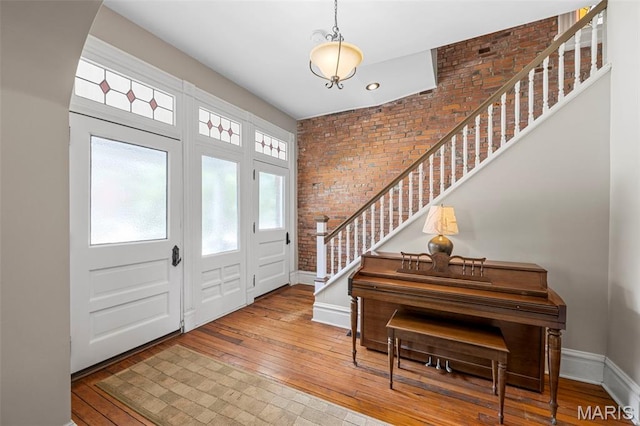 2612 S Compton Ave, Saint Louis, MO 63118 - entryway featuring brick wall, stairs, and wood-type flooring