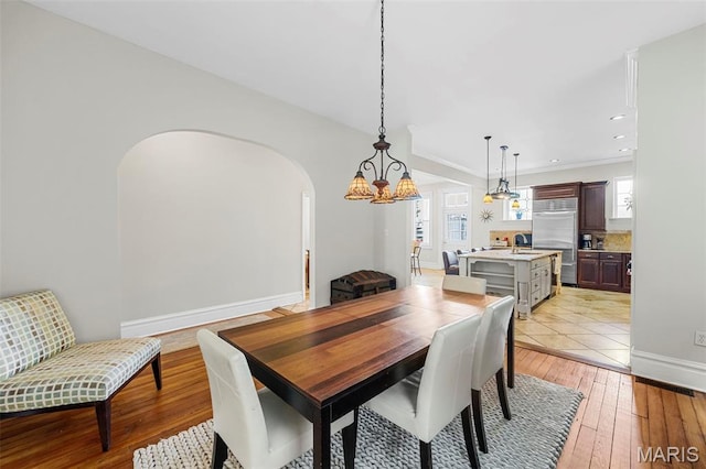2612 S Compton Ave, Saint Louis, MO 63118 - dining space with arched walkways, light wood-type flooring, and recessed lighting