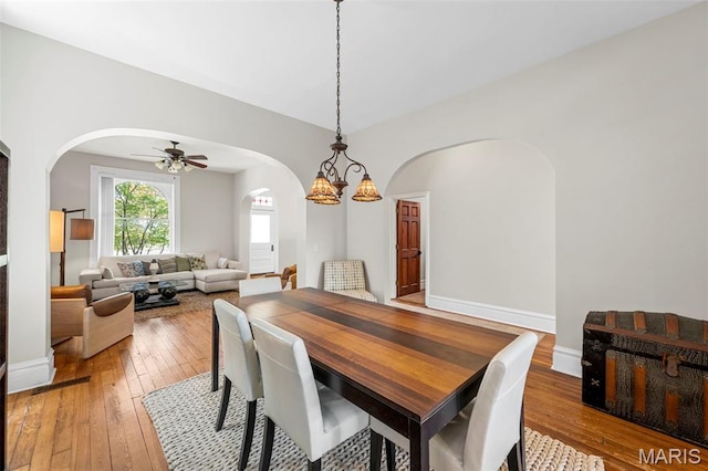 2612 S Compton Ave, Saint Louis, MO 63118 - dining space featuring arched walkways, light wood-type flooring, and a ceiling fan