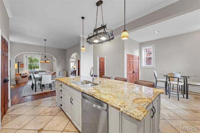 2612 S Compton Ave, Saint Louis, MO 63118 - kitchen featuring dishwasher, arched walkways, pendant lighting, crown molding, and light stone countertops