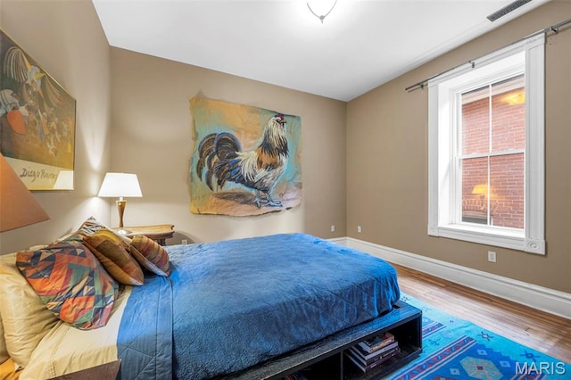 2612 S Compton Ave, Saint Louis, MO 63118 - bedroom featuring wood finished floors and baseboards