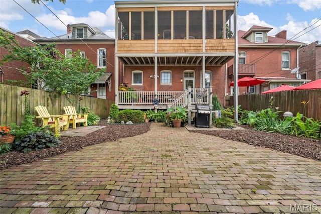 2612 S Compton Ave, Saint Louis, MO 63118 - rear view of property with a fenced backyard, brick siding, a porch, and a patio area