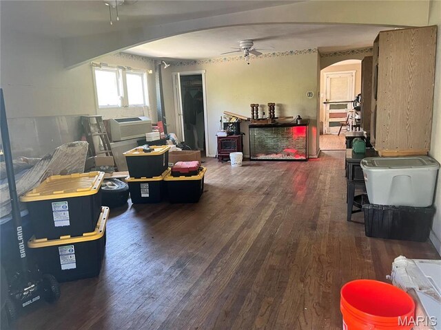 10058 Bon Oak Dr, Saint Louis, MO 63136 - living area featuring arched walkways, ceiling fan, wood finished floors, and cooling unit