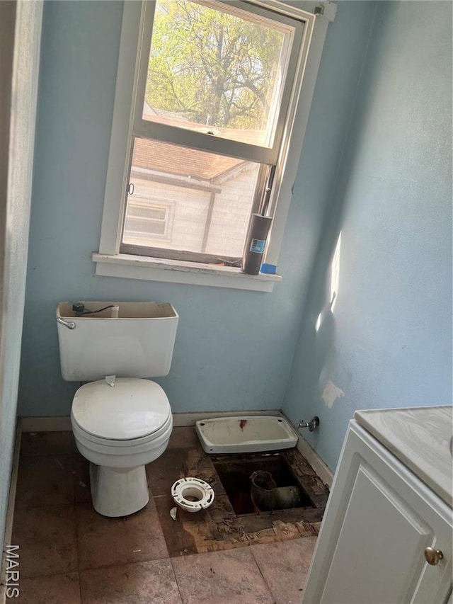 10058 Bon Oak Dr, Saint Louis, MO 63136 - bathroom with healthy amount of natural light, baseboards, toilet, and vanity